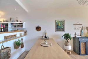 a dining room with a wooden table and potted plants at Bel appartement cozy avec magnifique vue mer in Ajaccio