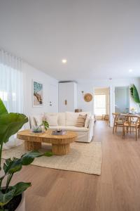 a living room with a couch and a coffee table at ILUKA Luxe accommodation, relaxed coastal vibe in Aldinga Beach