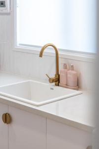 a sink with two soap bottles on a counter at ILUKA Luxe accommodation, relaxed coastal vibe in Aldinga Beach +16 photos