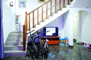 a bike parked in a living room with a staircase at DRS Luxury Holiday Homes in Kalutara