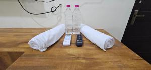a table with two remote controls and a wii controller at Sun Residency Tvm in Tiruvannāmalai