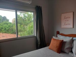 HorizonteにあるHostel Horizonte Cearáのベッドと景色の見える窓のある寝室