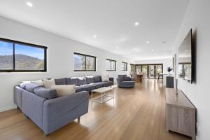 a living room with a couch and a table at Black Diamond - Luxury Alpine Home in Merrijig - Sleeps 14 in Merrijig