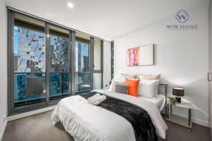 a bedroom with a large bed and a large window at WOW Apartment on Spencer in Melbourne +146 photos