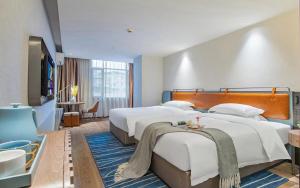 Katil atau katil-katil dalam bilik di Echarm Hotel Guangzhou Jiahe Helong Branch