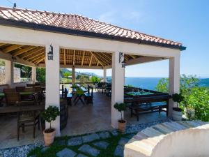 a pavilion with tables and a view of the ocean at Apartment with sea view in Orasac in Orasac