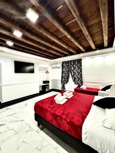 a bedroom with a red bed and a flat screen tv at Relais Parlamento in Rome