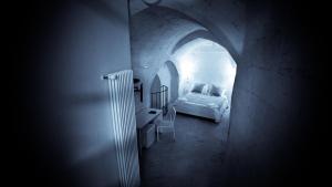 A bed or beds in a room at Giardini di Pietra