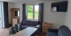 a living room with a couch and a table at Domki Gaładuś in Radziucie