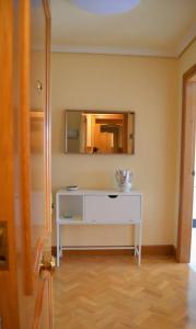 a room with a white dresser and a mirror at Acogedor piso con vistas en Sada in Sada