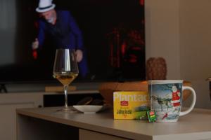 a glass of wine next to a glass of wine at Apartmani Grot Pale in Pale