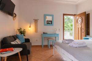 a room with a bed and a couch and a table at Golden Sun in Parga +48 photos