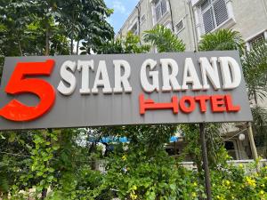 a star grand hotel sign in front of a building at Hotel 5 star grand in Shamshabad