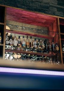 a group of bottles of alcohol on a shelf at Loch Earn leisure park in Saint Fillans