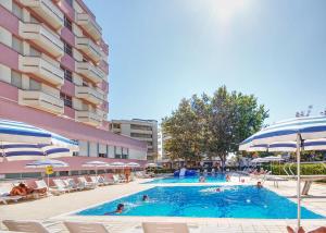 a large swimming pool with people in a hotel at Hotel Alba D'Oro in Gatteo a Mare