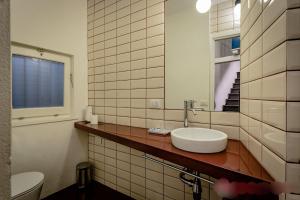 a bathroom with a sink and a mirror and a toilet at Open Suite Cobalto in Cagliari +150 photos