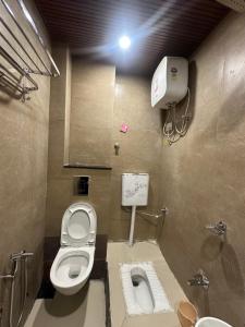 a bathroom with a toilet and a sink at HOTEL PREMIER CHOICE - JUST 50 Meters FROM AJMER SHARIF DARGAH in Ajmer