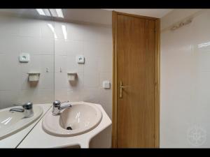 a bathroom with a sink and a mirror at ANEC en Baqueira in Naut Aran +10 photos