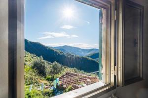 a window with a view of a mountain at Room in the Country House in Argallo +4 photos