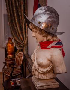 a statue of a child wearing a hat on its back at Emire Boutique in Zărneşti