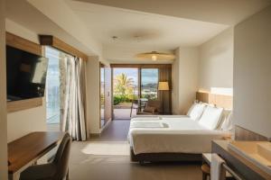 a hotel room with a bed and a balcony at BANCAL HOTEL and SPA in San Sebastián de la Gomera