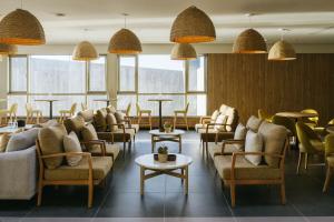 a waiting room with couches and tables and windows at BANCAL HOTEL and SPA in San Sebastián de la Gomera