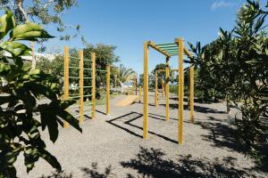 a playground with yellow poles in a park at BANCAL HOTEL and SPA in San Sebastián de la Gomera