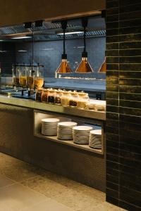 a restaurant kitchen with plates on a counter at BANCAL HOTEL and SPA in San Sebastián de la Gomera