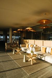a lobby with couches and tables in a building at BANCAL HOTEL and SPA in San Sebastián de la Gomera