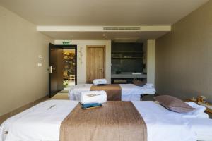 a hotel room with three beds in a room at BANCAL HOTEL and SPA in San Sebastián de la Gomera