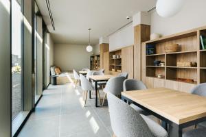 a dining room with wooden tables and chairs at BANCAL HOTEL and SPA in San Sebastián de la Gomera