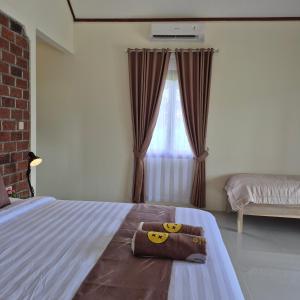 Postel nebo postele na pokoji v ubytování Rice Field inn - Lombok