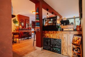 a restaurant with a surfboard on the wall and a bar at Aparthotel Jacques van Marken Erfgoed in Delft
