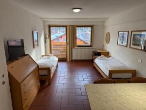 a hospital room with two beds and a table at Top Apartments in Passo del Tonale
