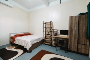 a bedroom with a bed and a desk at Urban Haven Residence in Sanur