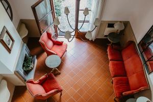 Draufsicht auf ein Wohnzimmer mit roten Stühlen in der Unterkunft Ginestriccio in Bibbona