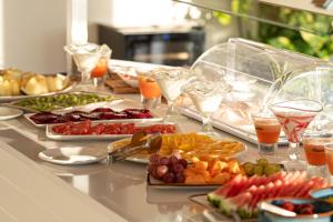 a buffet with many plates of food and drinks at Royal Marina Suites Boutique Hotel - Adults Only in Puerto Calero