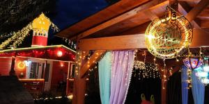 a house decorated with christmas lights and a chandelier at Refugio madera estilo árabe con estatuas, estanques y un pequeño zoo in Albacete