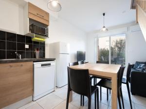 a kitchen and dining room with a table and chairs at La Dune 38 - Villa 3P6 in Valras-Plage