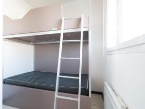 a bunk bed in a room with a ladder at La Dune 38 - Villa 3P6 in Valras-Plage +8 photos