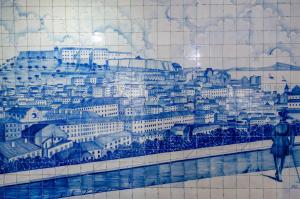 a tile wall with a painting of a city at Hotel Principe Real in Lisbon