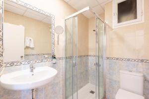 a bathroom with a sink and a shower and a toilet at The Red Hotel - Adults Only in San Antonio