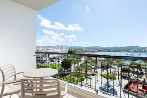 a balcony with a table and chairs and a view of a harbor at The Red Hotel - Adults Only in San Antonio