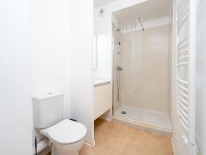 a white bathroom with a toilet and a shower at La Dune B 203 - ST2 in Valras-Plage +18 photos