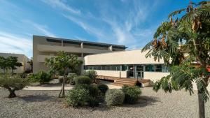 a building with a lot of trees in front of it at La Dune B 203 - ST2 in Valras-Plage
