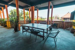 a wooden table and two chairs on a patio at Urban Haven Residence in Sanur