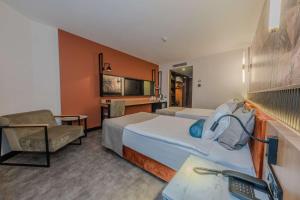 a hotel room with a bed and a chair at Best Western Plus Khan Hotel in Antalya