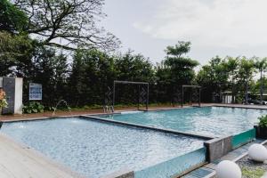 a large swimming pool with blue water at Sweet Home Ipoh Oasis Condominium in Ipoh