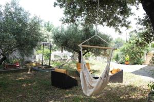 a hammock hanging from a tree in a yard at Pleasant part of house with pool to share in Vaucluse, 4/6 people in Puget +32 photos