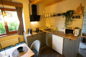 a kitchen with a table and a counter top at Rustic Comfort House in Miercurea-Ciuc